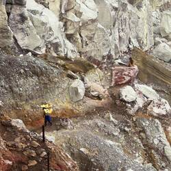 Porters carry sulphur, weighing more than their body weight, out of the steep-sided crater.