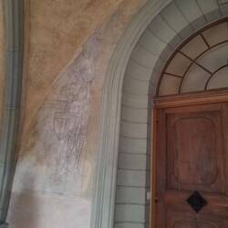 Faded frescoes in the entryway.