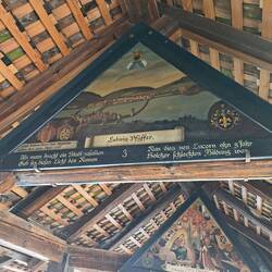 The roof trusses are decorate with art depicting the town's history.