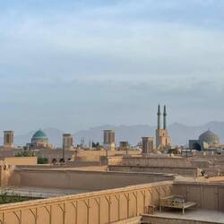 Overseeing the rooftops and wind towers of the town.