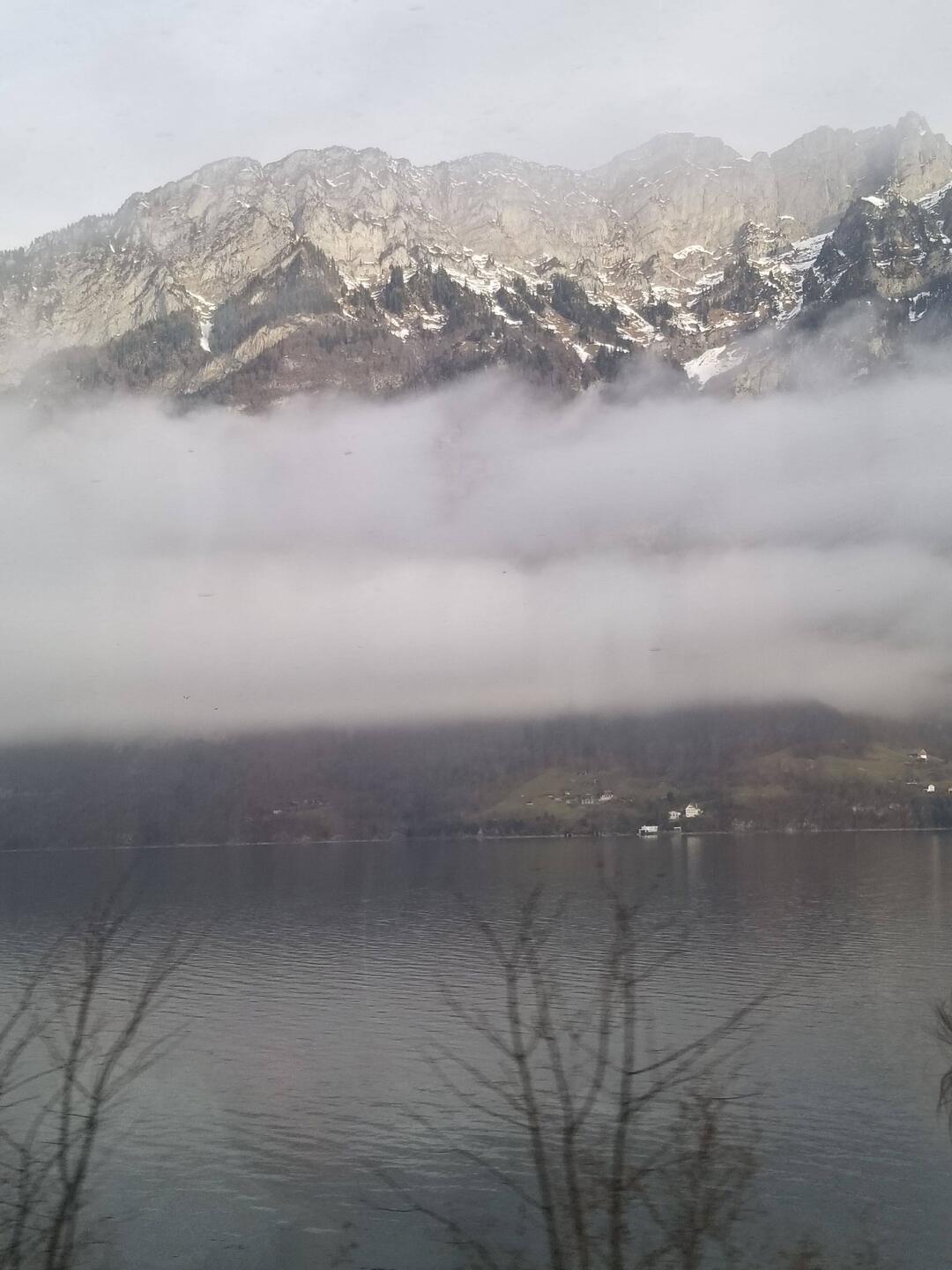 Walensee overlooked by stone cliffs, draped in taffeta.