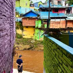We follow narrow winding streets, descending to the fast brown Brantas river.