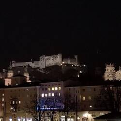 Alstadt ay night in lights overlooking the river.