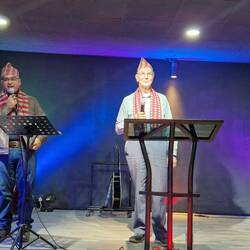 Trevor preaching, Milan interpreting.