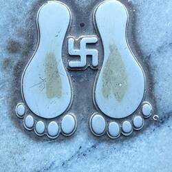 I'm now enlightened with regards to both the swastik and tiny footprints as you enter a house