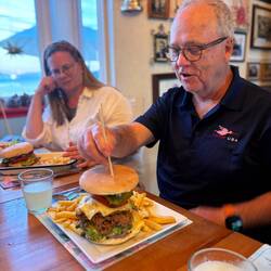 Giant meat sandwich with avocado, green beans, and cheese.