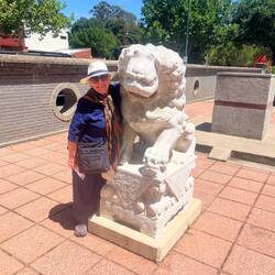 Woman embraces lion.