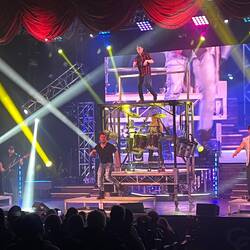 Boys tapdancing. Cat in the center on the drums.