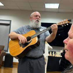 Catfish playing guitar and singing.