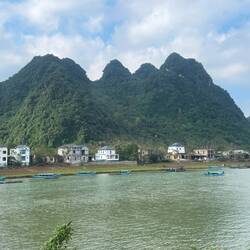 Karst hills and boats to transport to cave