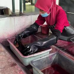 Smaller pieces of fabric are dyed in shallow dye troughs