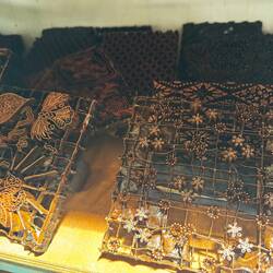 Copper stamps (caps) to apply wax to the fabric. 100s of different designs lined up on shelves 🤩.