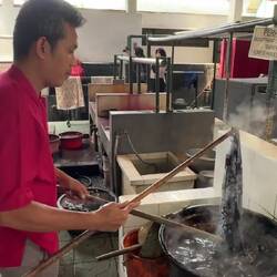 Waxed fabric is put into boiling water to remove the wax and reveal the pattern