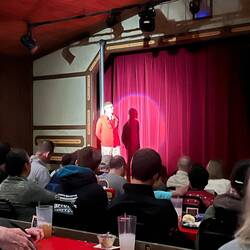 The narrator of the play. Rosanne says it was a popular play story.