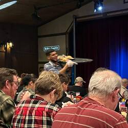 One of the servers making his way between rows of tables.
