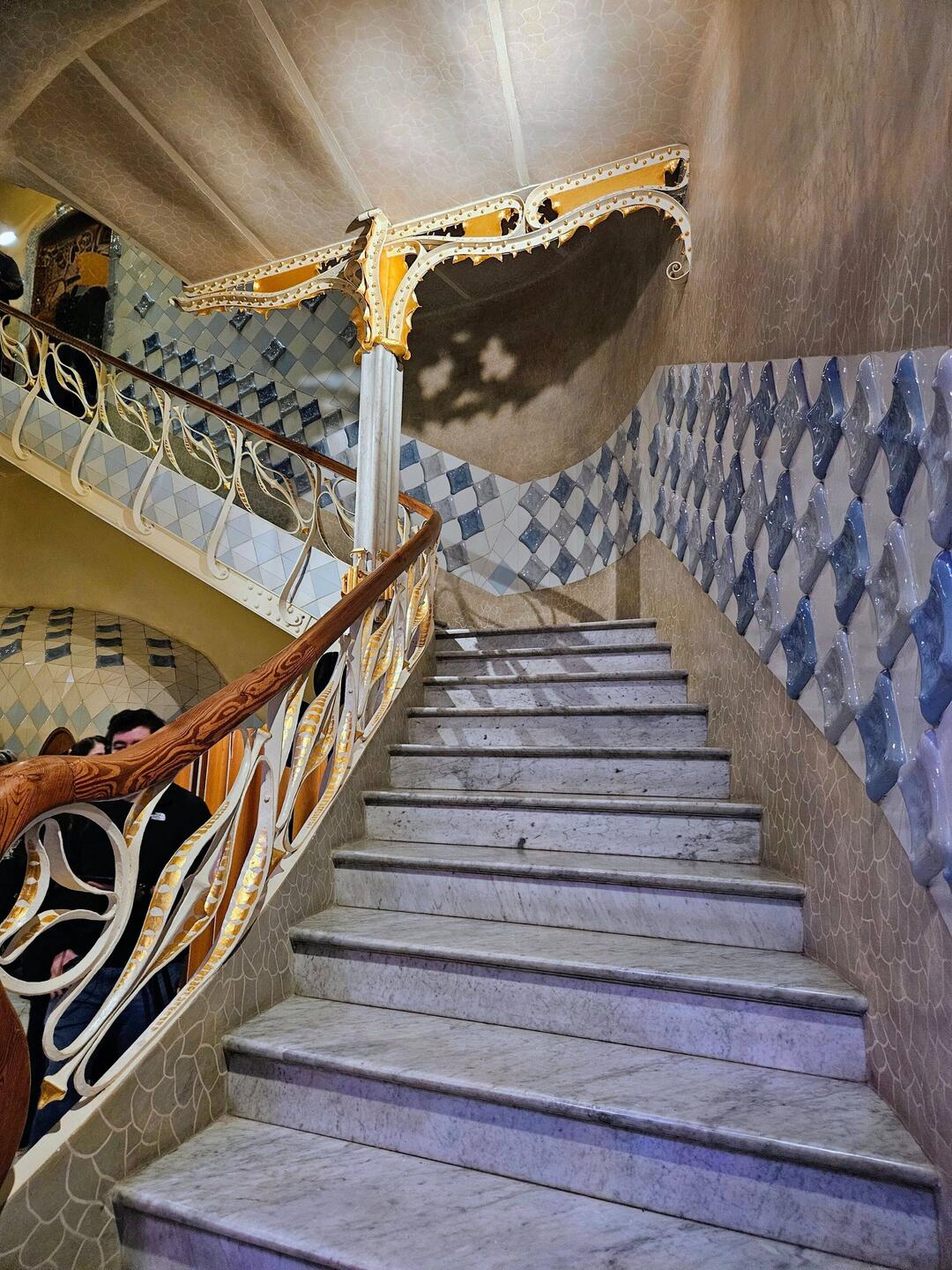 Colorful tiles and naturalistic banister lines this stairway in Casa Batlio