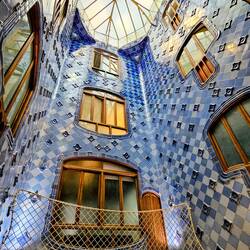 Blue tiles darken as they rise up atrium to the roof