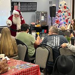 Santa Claus pointing for bell ringers.