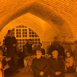 Locals singing and hanging out under a bridge