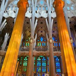 The rays of the Western sun through the stained glass colors the pillars!