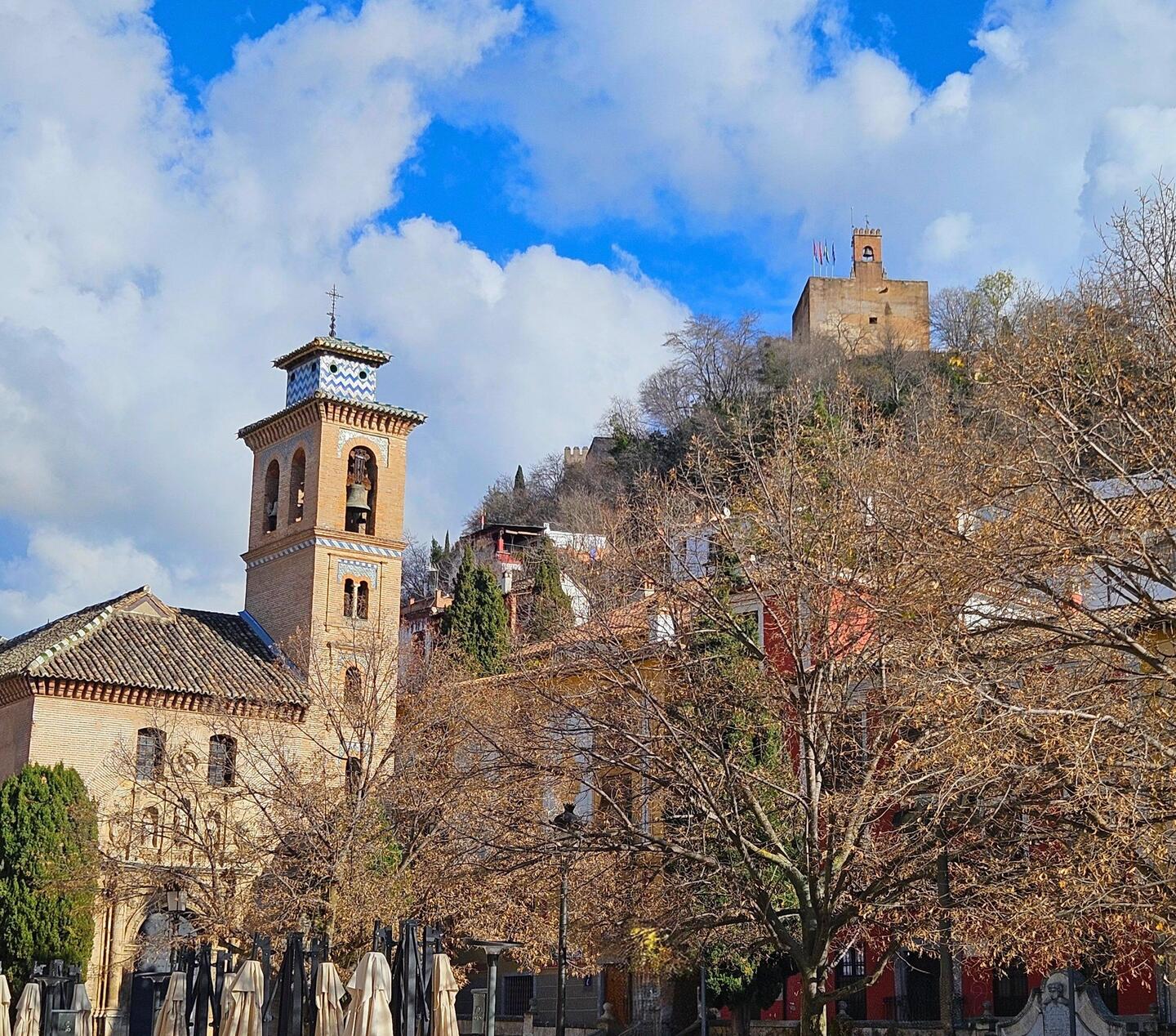 Walking on Calle Reyes Catolicos (Catholic Kings St), looking up to the Alhambra high on the hilltop