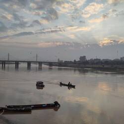 The Karun River washes some of the city's trash away. Still, people make a living of these waters