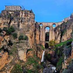 A short hike down reveals the upper waterfall with bridge