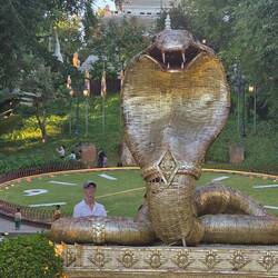 Snake sculpture guards the clock and temple