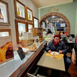 Lucica, my mother, enjoys some local products in a small shop.