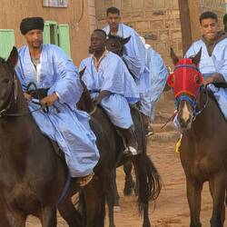 Traditional riders greet us as we enter the town.