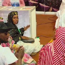 Suddenly two women start to clap, after two minutes 20 are drumming and clapping