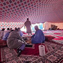 Small groups around a large tray per group