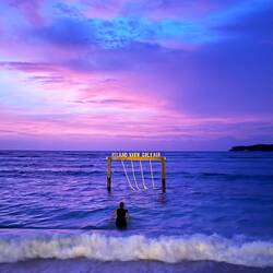 The famous beach swing. Dressed for dinner, we decided to wade out to it