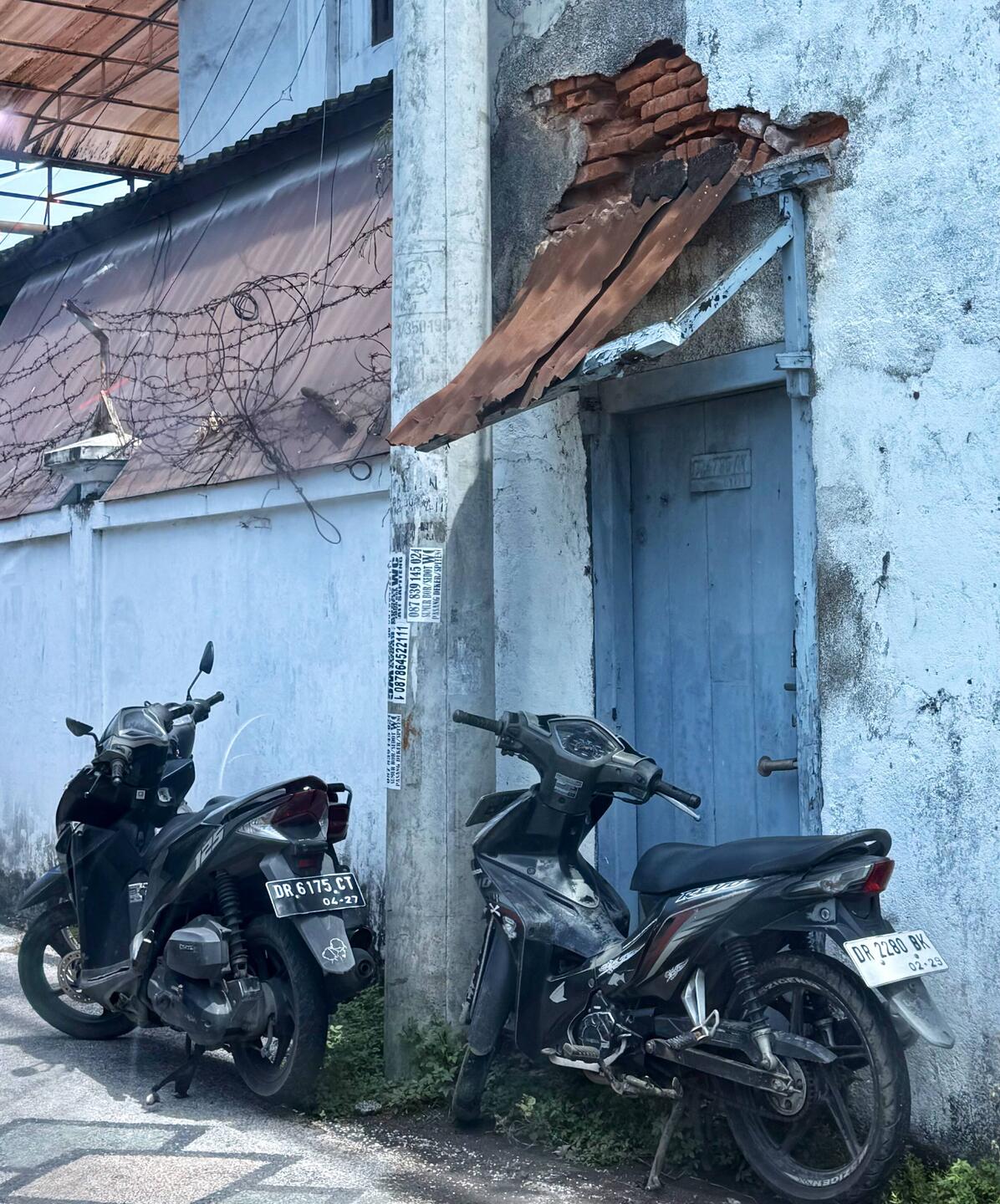 This doorway and aged awning caught my eye. Look at the weathered bricks at the top of the door