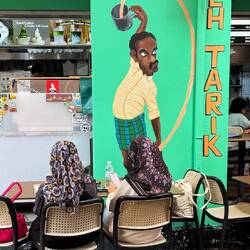 Teh tarik is THE drink here. Translated as 'pulled tea' - what the gentleman is doing here.