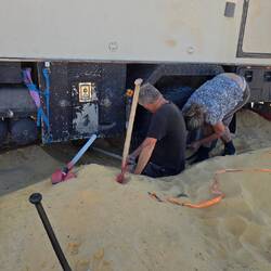 Roland has dug his truck in so deep that both axles were deep in the sand