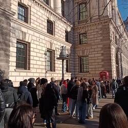 Queues of tourists waiting to get a photo with a phone box and Big Ben in the background
