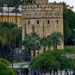 Torre del Oro with kayaker in foreground and cathedral spire in background