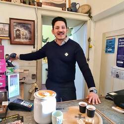 Roger dishing out 'the dole' of beer & bread