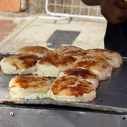 Cornmeal dough with salt, butter, and melted cheese cooked inside or on top. Arepas.