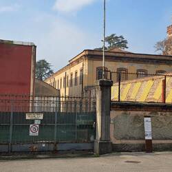 Crespi d'Adda. Rusty remains of industrialisation behing closed gates...