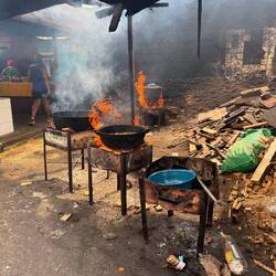 Fire pits used for cooking meat for local vendors and families.
