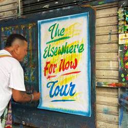 Posters by a well-known local graphic artist displayed in the market.