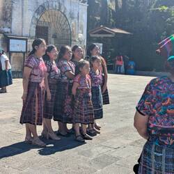 Family in traditional mayan clothing. The various designs represent status, area, and eligibility