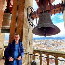 Charlie with one of 15 bells at top of bell tower