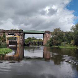 The dry dock to the left with the stopgate being lifted by the yellow gantry