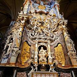 Second altarpiece, the Baroque Transparente. Towering structure with tiers of sculptures.