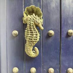 Ornate bronze door knockers once signaled family status and wealth in San Diego.