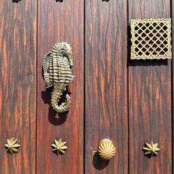 Ornate bronze door knockers once signaled family status and wealth in San Diego.