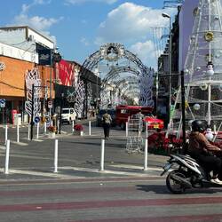 Thailand's Queen Mother recently passed away. The street has a banner with her picture.